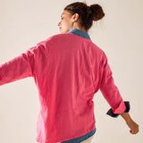 Woman wearing a pink jacket with a white background
