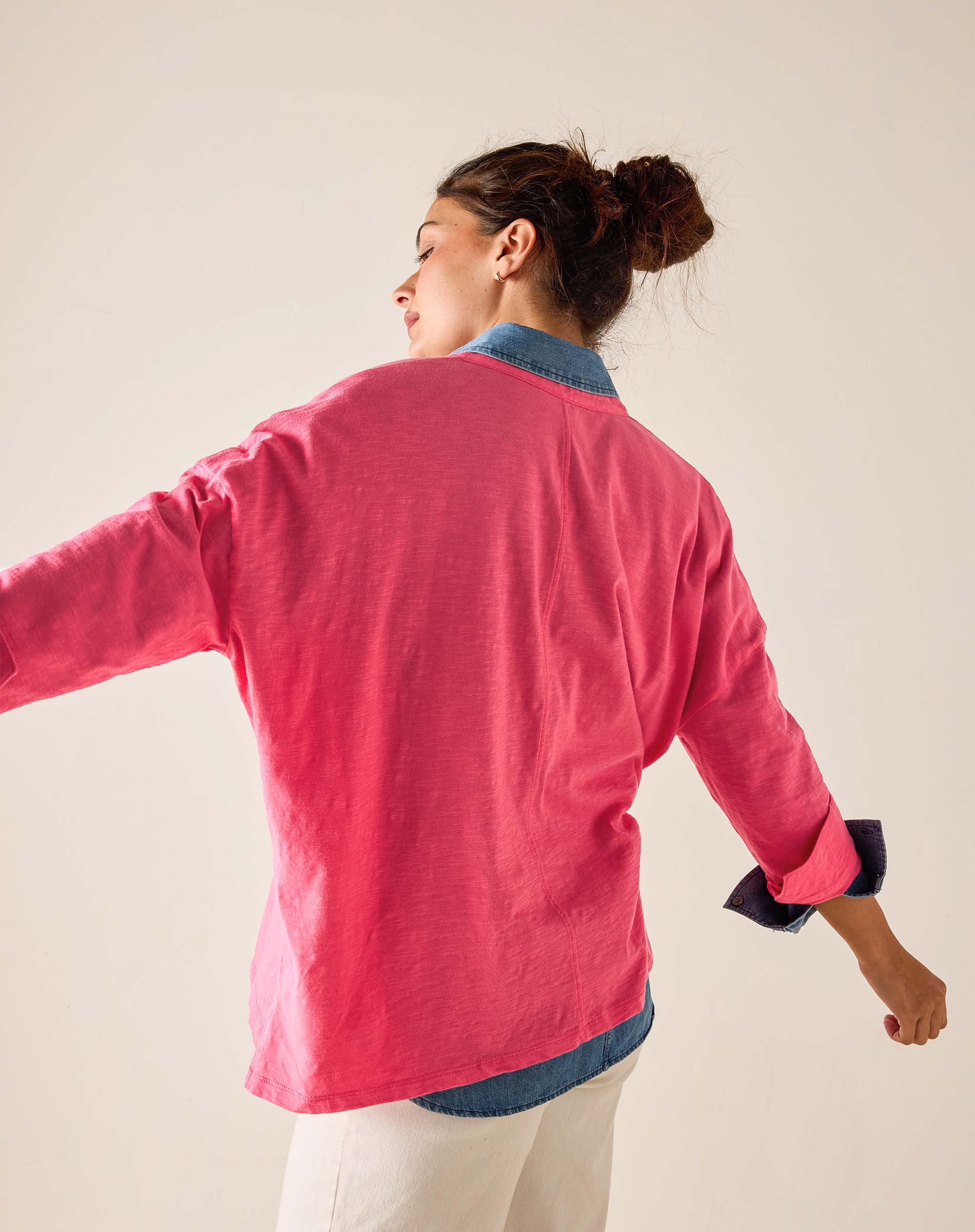 Woman wearing a pink jacket with a white background