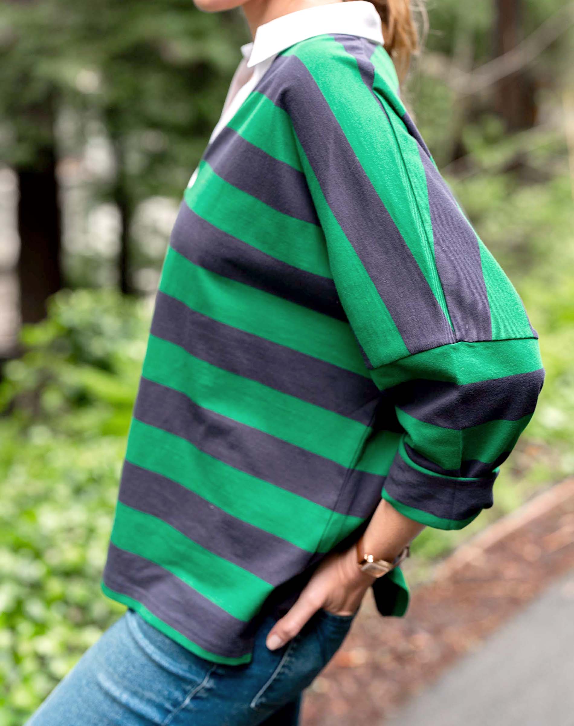 Person wearing a green and navy striped shirt outdoors