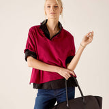 MERSEA women's travel-friendly berry and noir ruffled tee with a layered look over jeans.