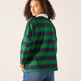 Person wearing a green and navy striped shirt on a beige background