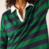 Person wearing a green and navy striped shirt with a white collar.