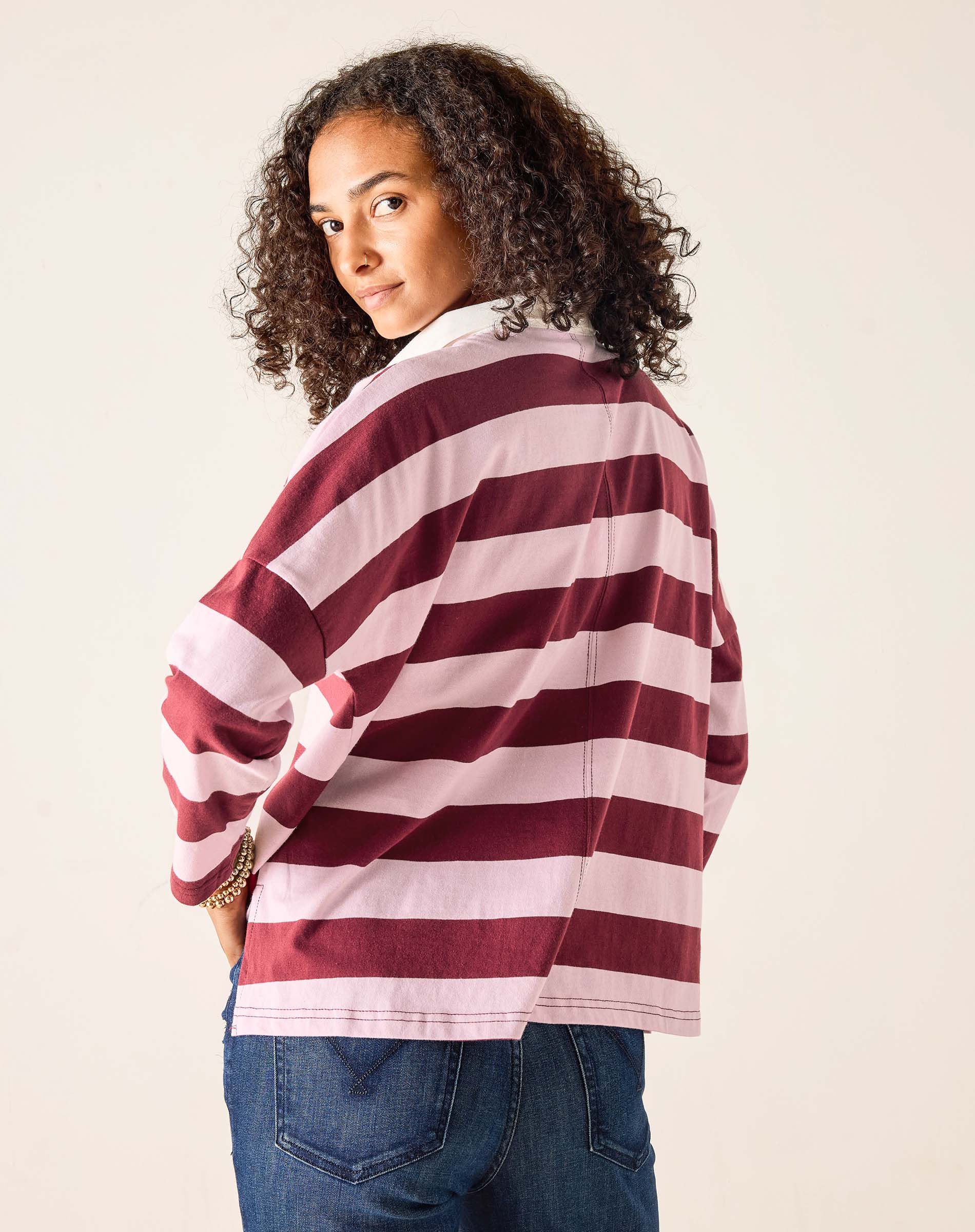 Person wearing a red and white striped sweater against a plain background
