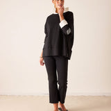 Ladies' travel-ready black oversized tunic tee with white gingham contrast collar and cuff detail.