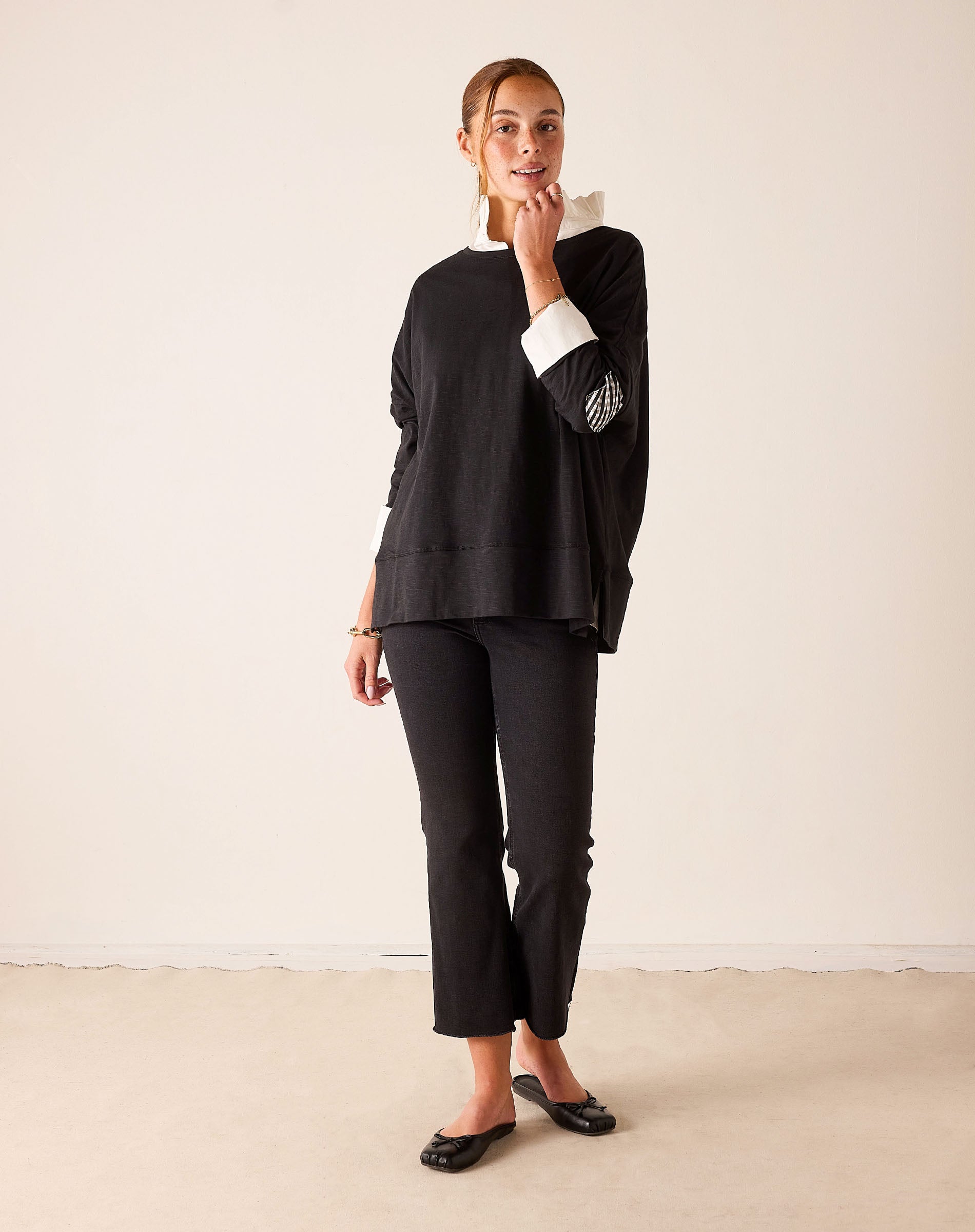 Ladies' travel-ready black oversized tunic tee with white gingham contrast collar and cuff detail.