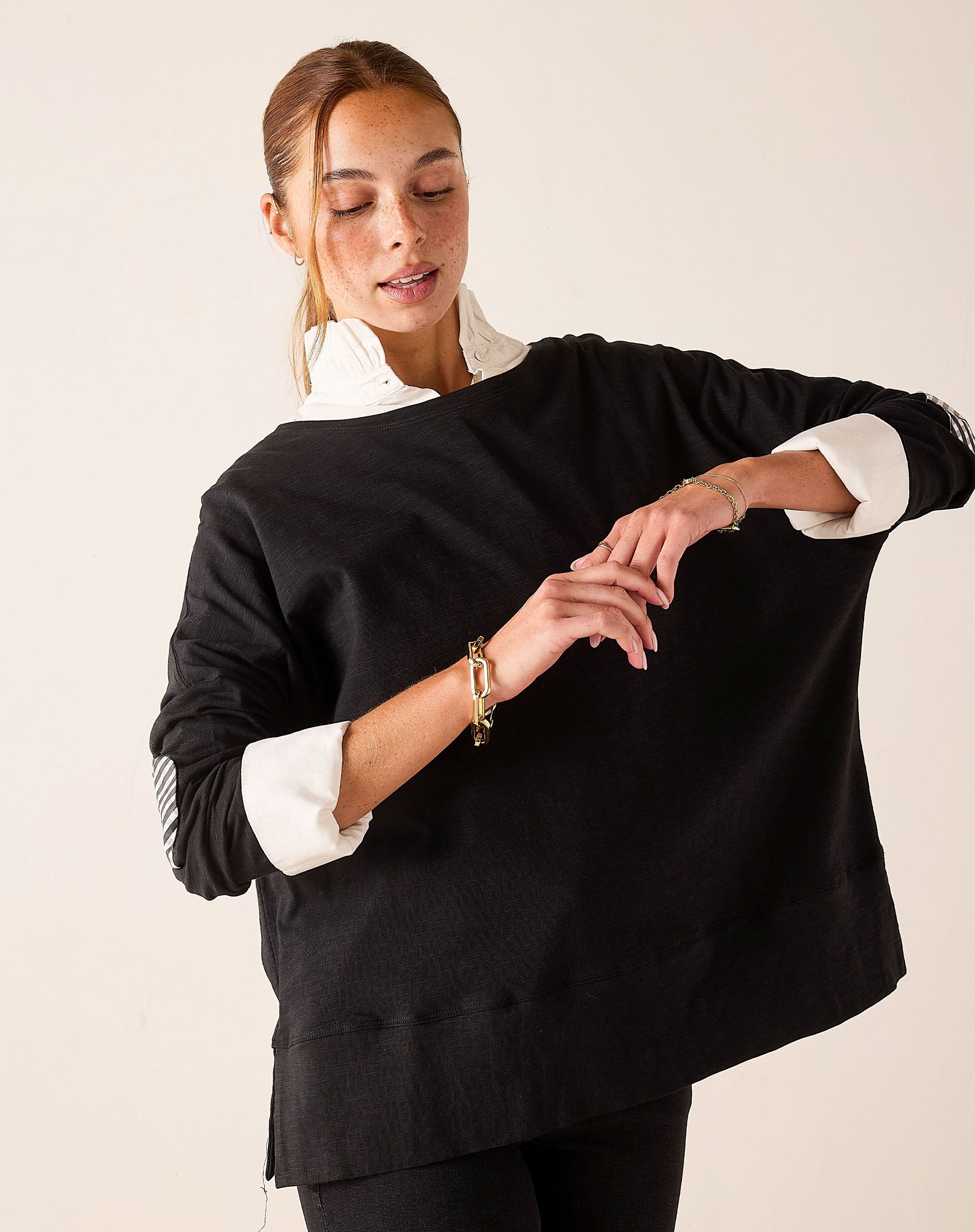 Black gingham appliqué tee featuring a layered shirt style with white collar and cuff details.