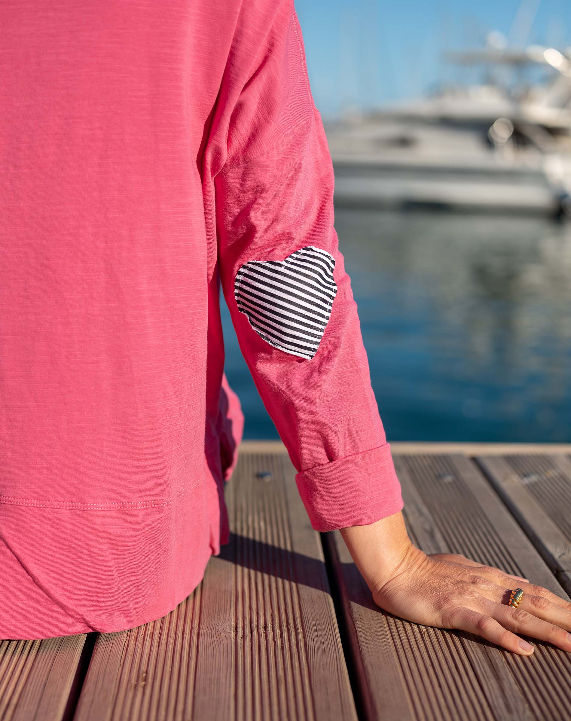 Rapture rose tee with a navy stripe heart applique on the sleeve.