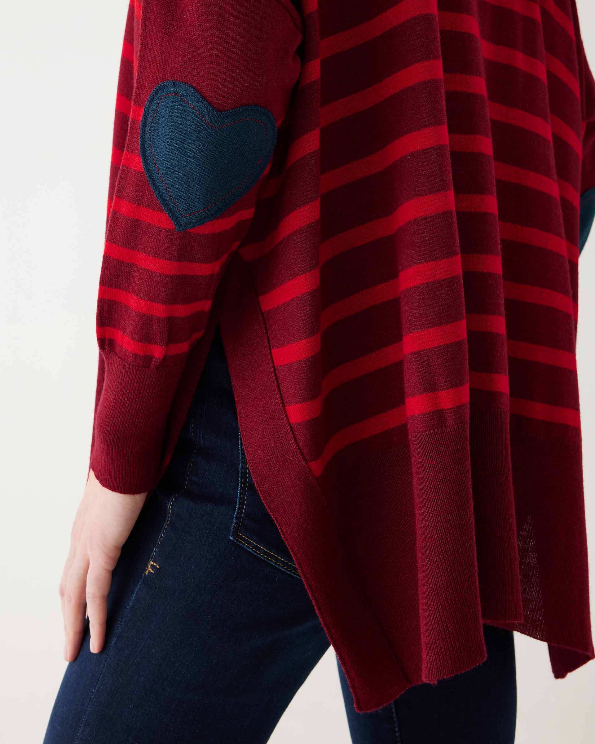 maroon sweater with red stripes and a navy heart elbow patch backwards on white background