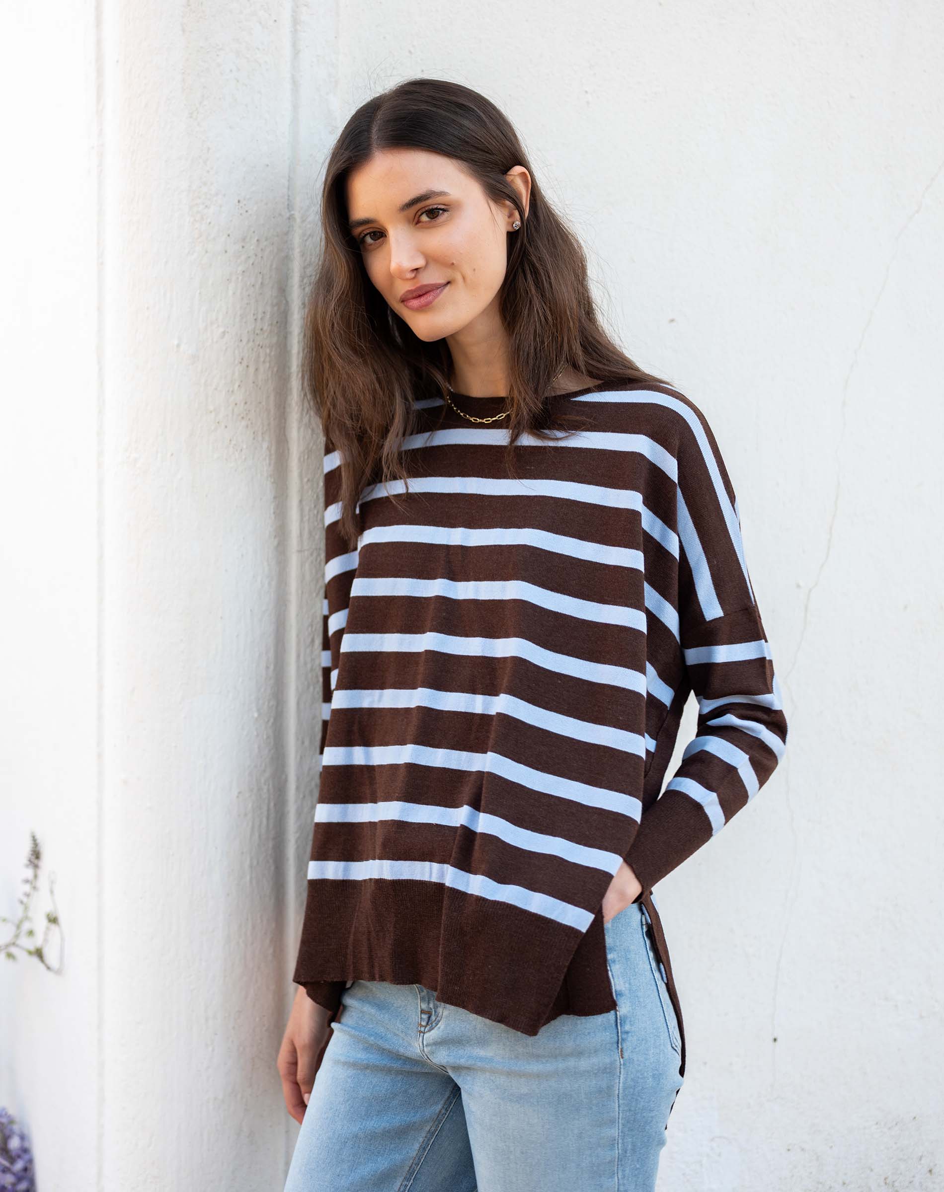 Chocolate icing and blue striped knit sweater with a relaxed fit and side slits.
