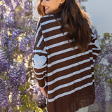 Chocolate icing and blue horizontal striped knit sweater with long sleeves.