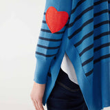 female wearing blue sweater with navy stripes and a red heart elbow patch on white background