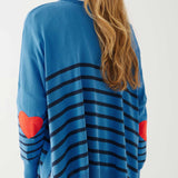 female wearing blue sweater with navy stripes and a red heart elbow patch on white background