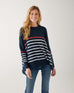 female wearing navy sweater with white stripes & red heart elbow patch on white background