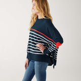 female wearing navy sweater with white stripes & red heart elbow patch sideways on white background