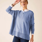 Ocean blue knit sweater with a white collar and small heart emblem.