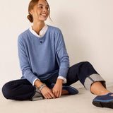 Ocean blue knit sweater with a white collar and heart detail.