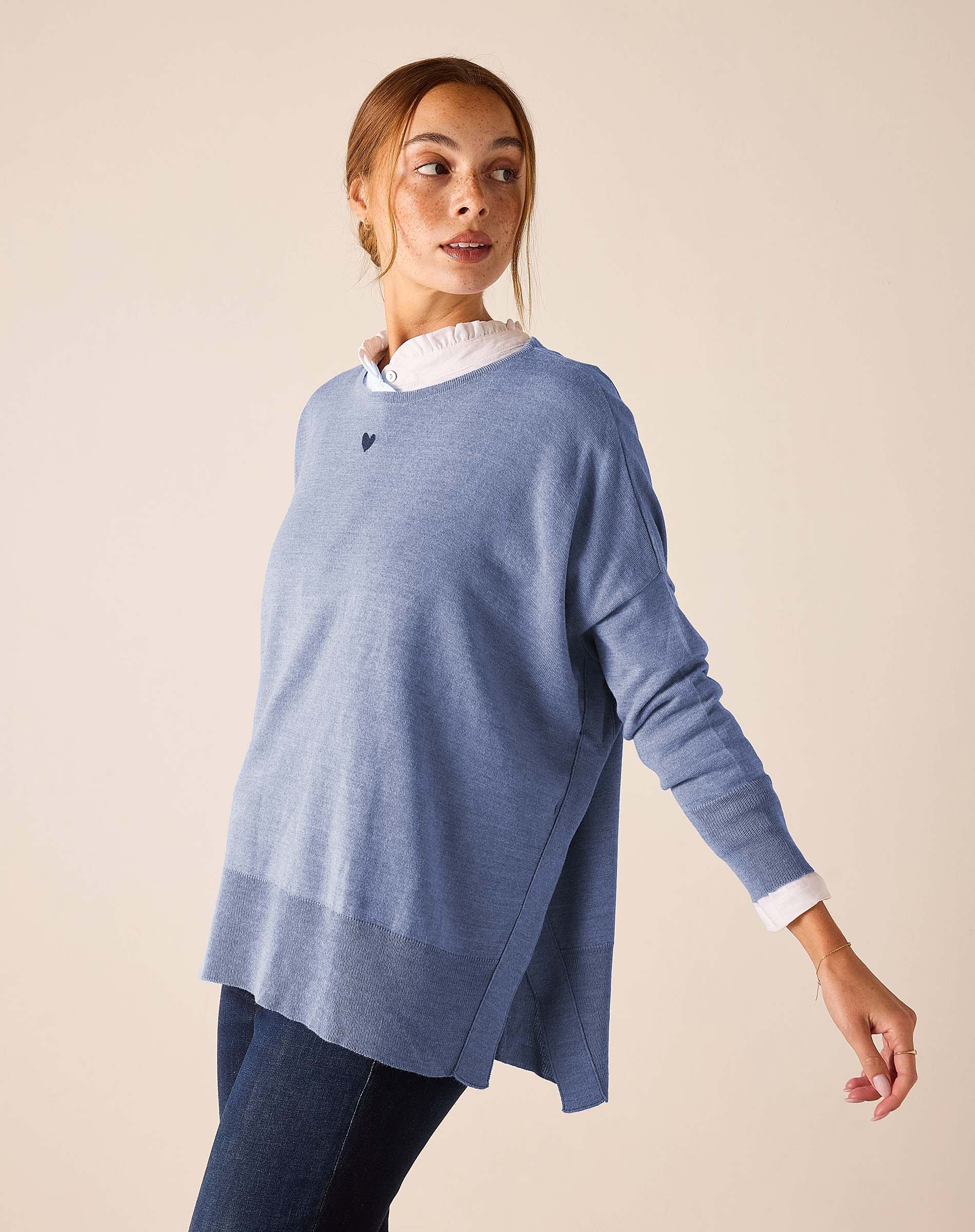 Ocean blue knit sweater with a layered look and a side slit.