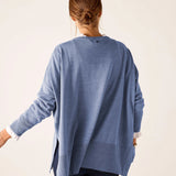 Back view of women's travel-friendly ocean blue knit sweater with a draped back and long sleeves.