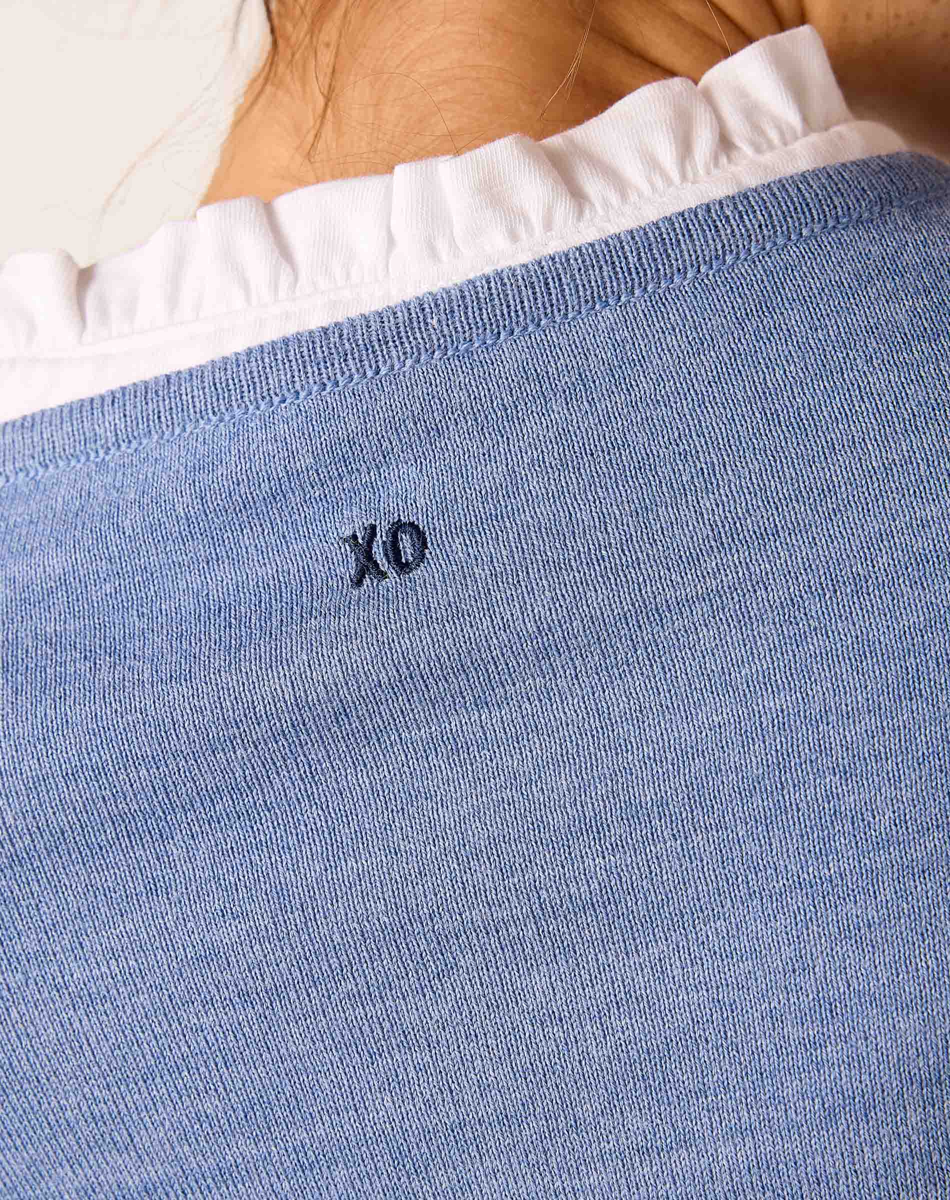 Ocean blue knit sweater with a ruffled white collar detail and 'XO' embroidered on the front.