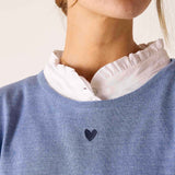 Ocean blue knit sweater featuring a small dark heart detail at the center of the chest.