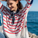 Red and white striped knit sweater with a navy heart detail on the sleeve.