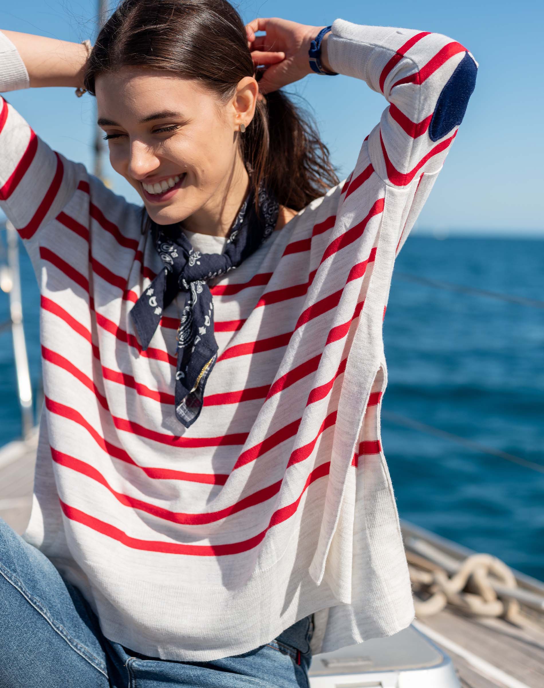 Red and white striped knit sweater with a navy heart detail on the sleeve.