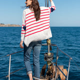 Back view of the white knit sweater with red stripes and navy heart accents.