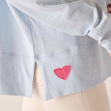 Light blue shirt with a pink heart design on a white background