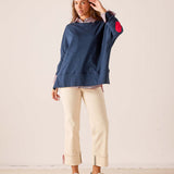 Women's travel-friendly navy blue relaxed-fit cotton tee with a red heart detail on the sleeve and a layered button-down collar.