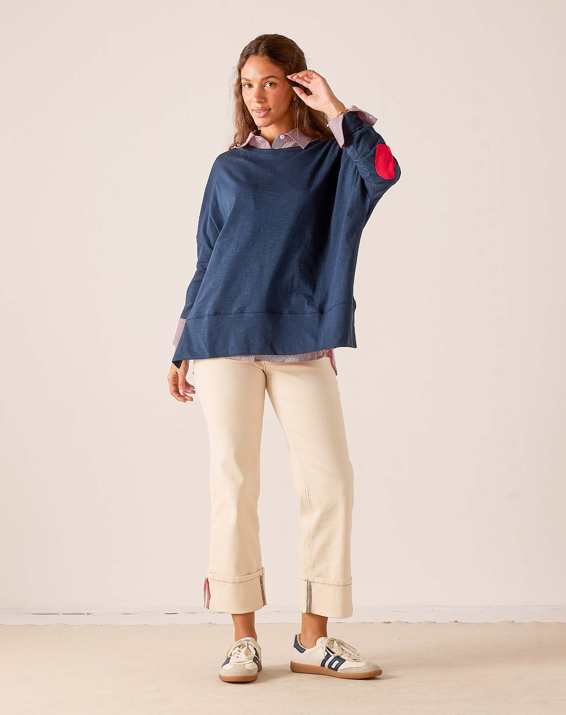 Women's travel-friendly navy blue relaxed-fit cotton tee with a red heart detail on the sleeve and a layered button-down collar.