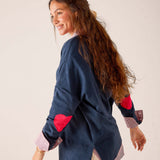 Navy blue button-down shirt with red heart patches on the sleeves and a light pink striped lining.