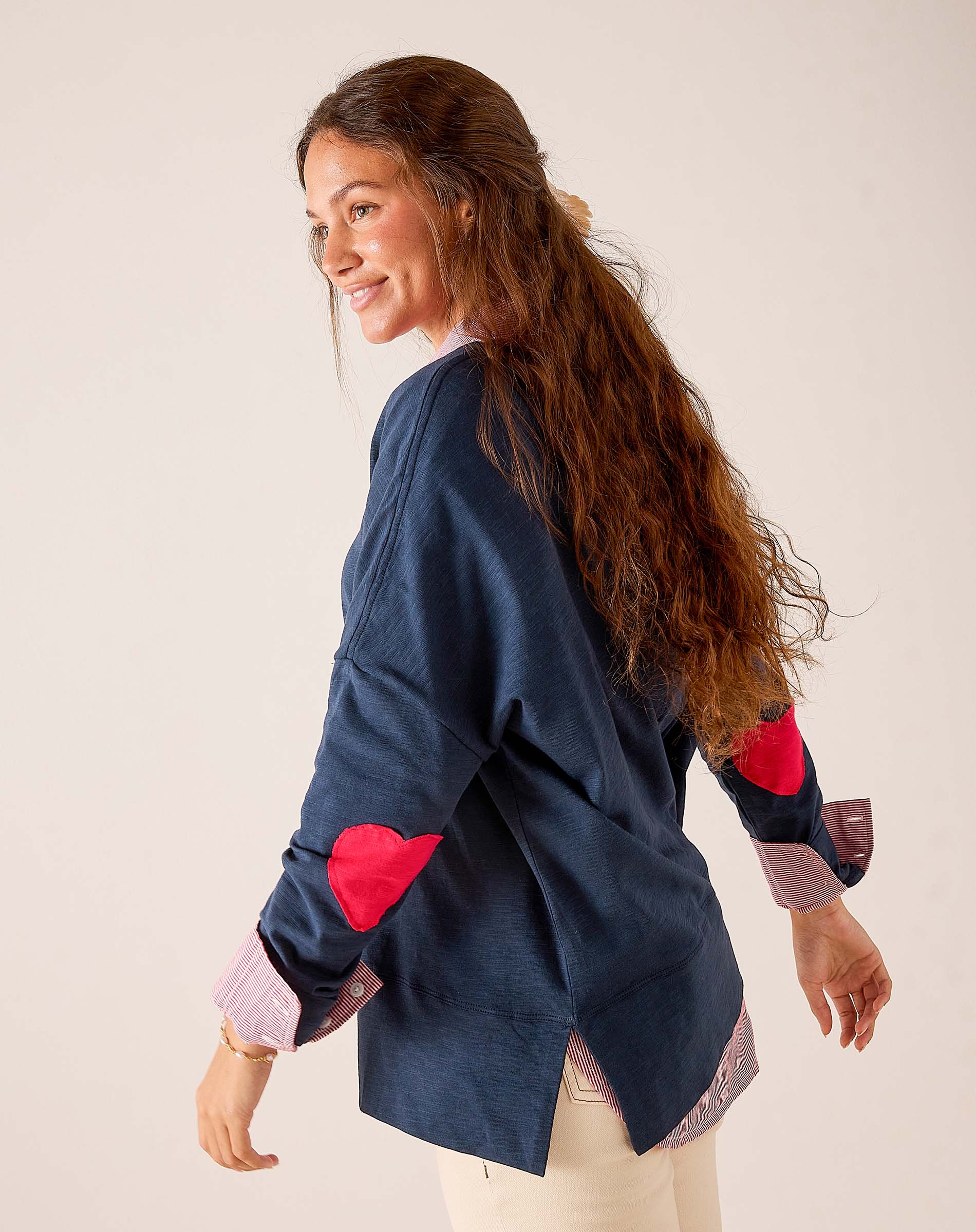 Navy blue button-down shirt with red heart patches on the sleeves and a light pink striped lining.