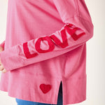 Pink sweatshirt with 'LOVE' and heart design on a white background