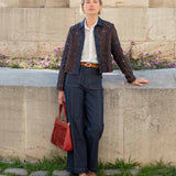 Navy blue woven pants with a subtle striped texture and wide legs.