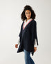 woman wearing mersea Anywear v new poncho in navy with red and white collar details