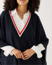 closeup of woman wearing mersea Anywear v new poncho in navy with red and white collar details