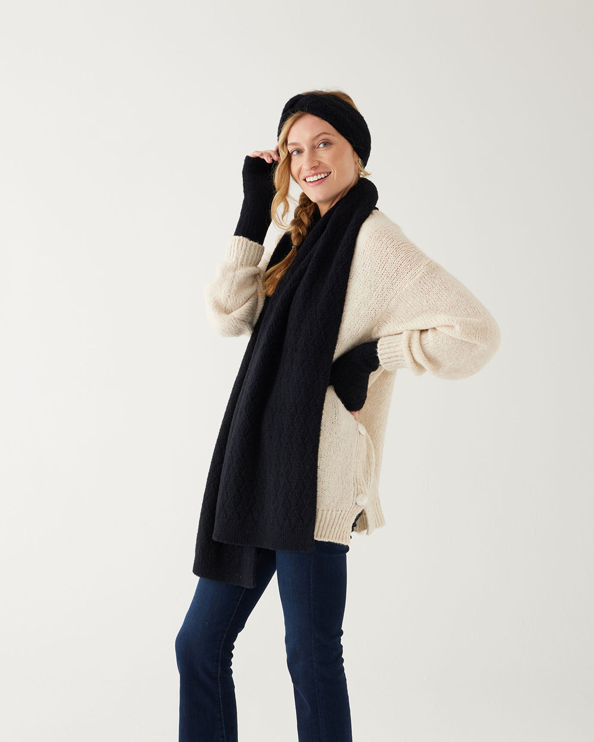profile of woman wearing mersea black apres scarf fingerless gloves and headband