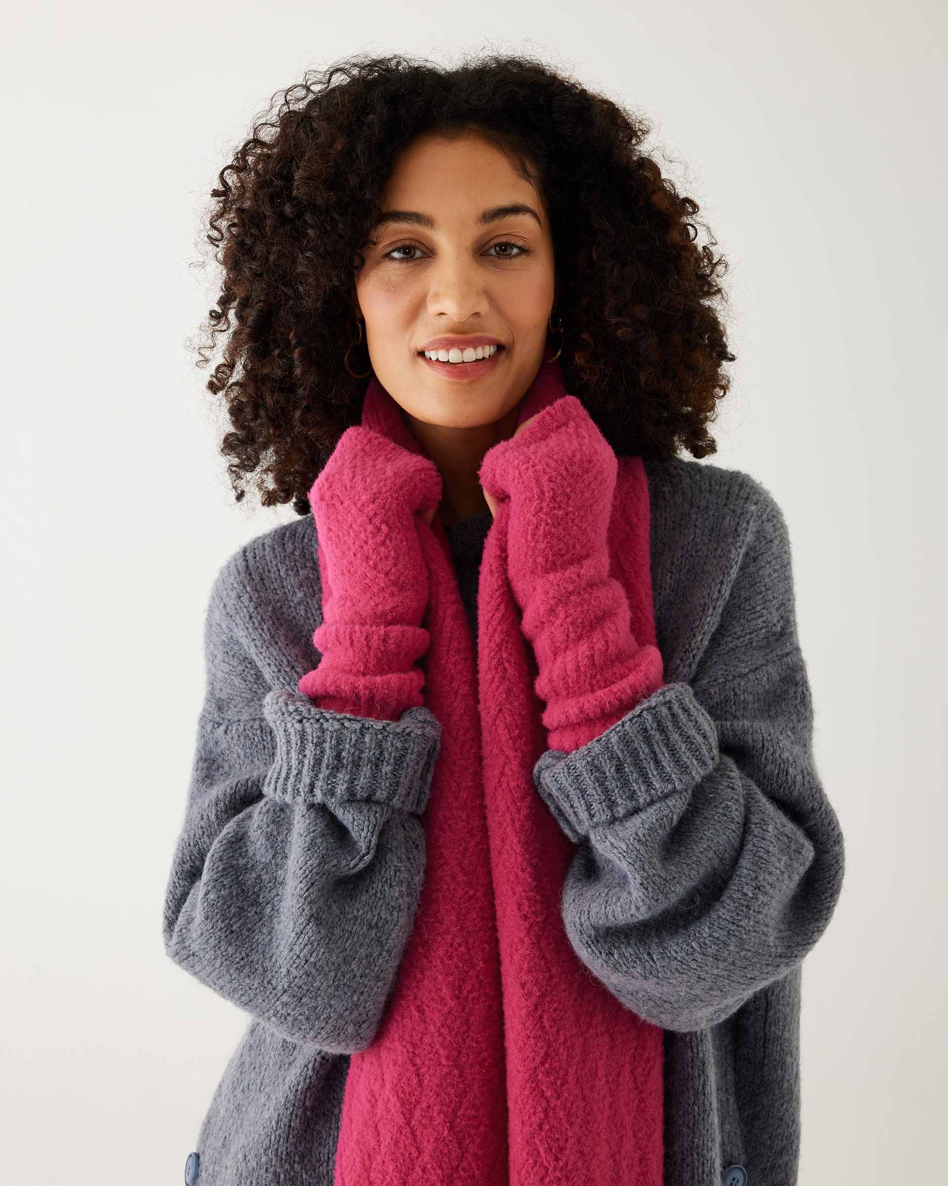 closeup of woman wearing mersea rasberry apres scarf and fingerless gloves