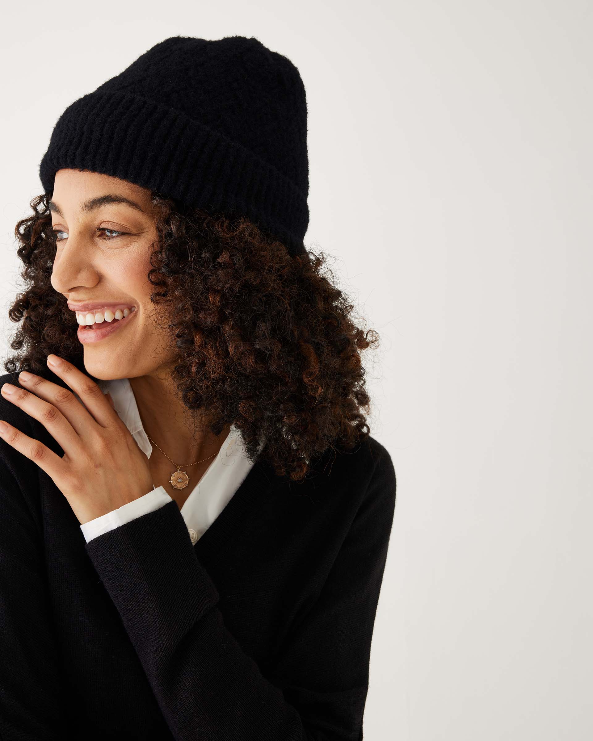 profile of woman wearing mersea black apres beanie