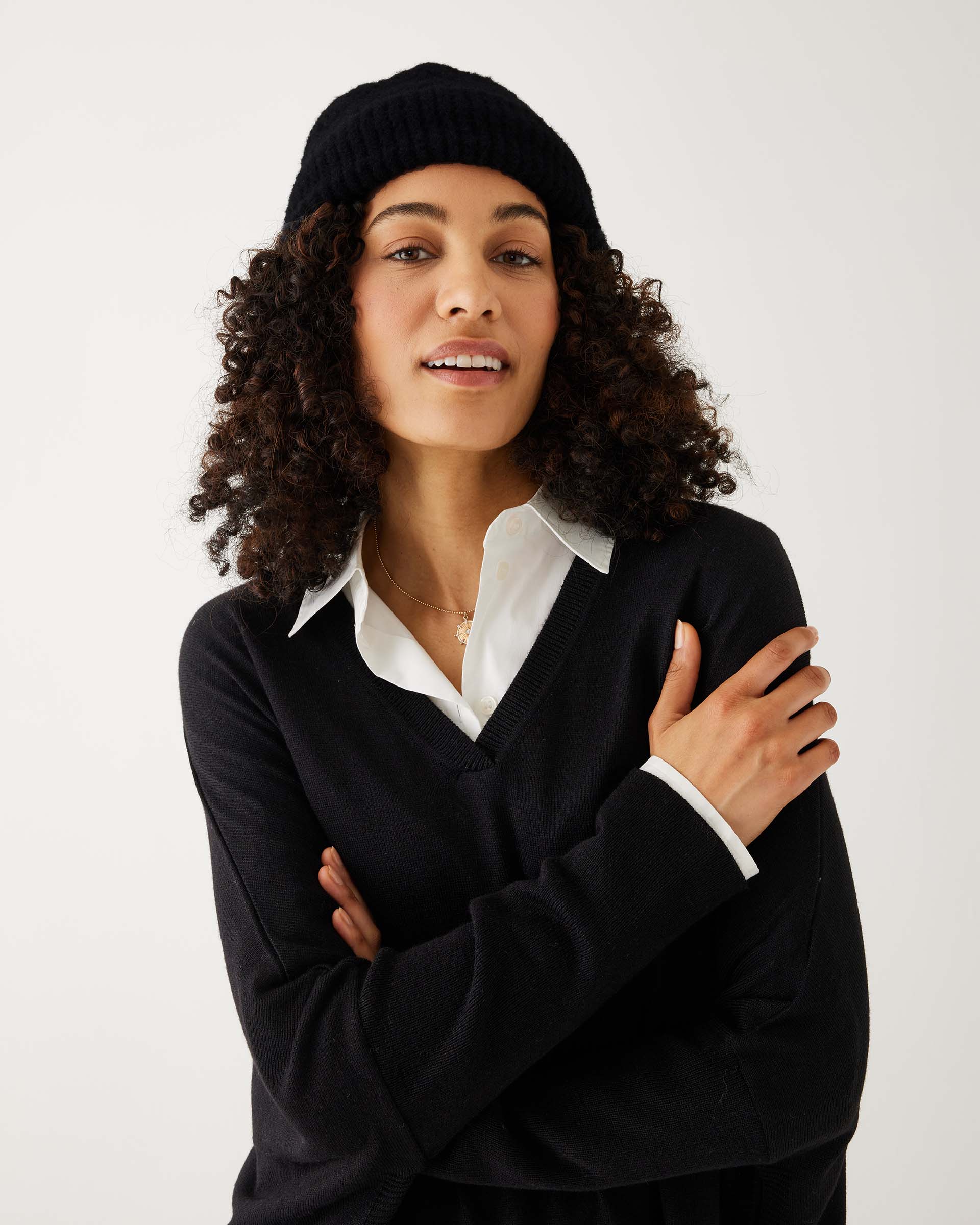 woman wearing mersea black apres beanie with arms crossed