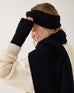 profile of woman wearing mersea black apres fingerless gloves headband and scarf