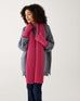 woman wearing mersea rasberry apres fingerless gloves and scarf