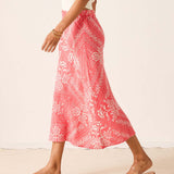 Person wearing a pink patterned skirt with white background