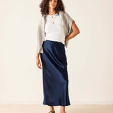 Women's travel-friendly navy blue satin midi skirt with a smooth sheen.