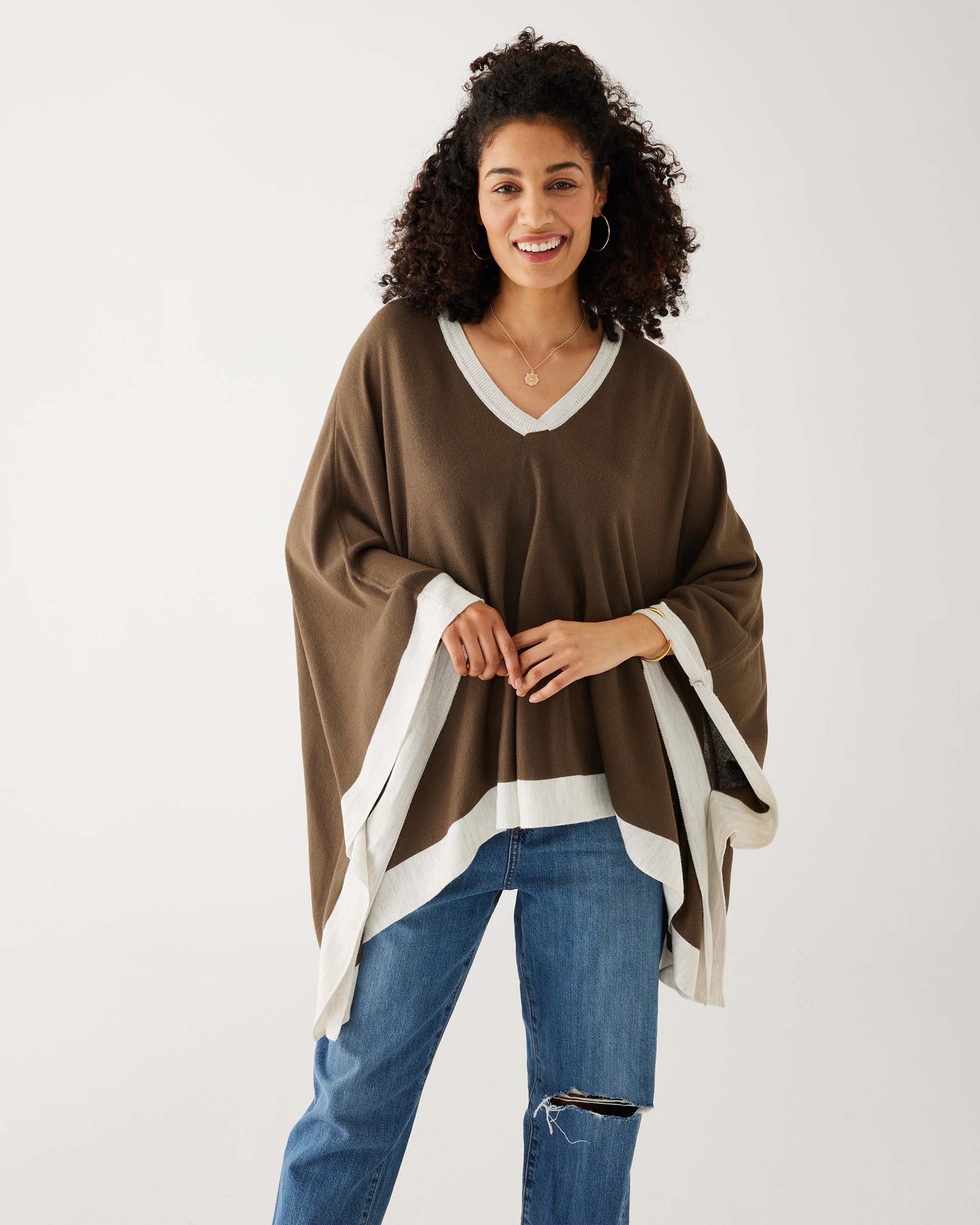 woman wearing mersea olive and sea salt avalon poncho