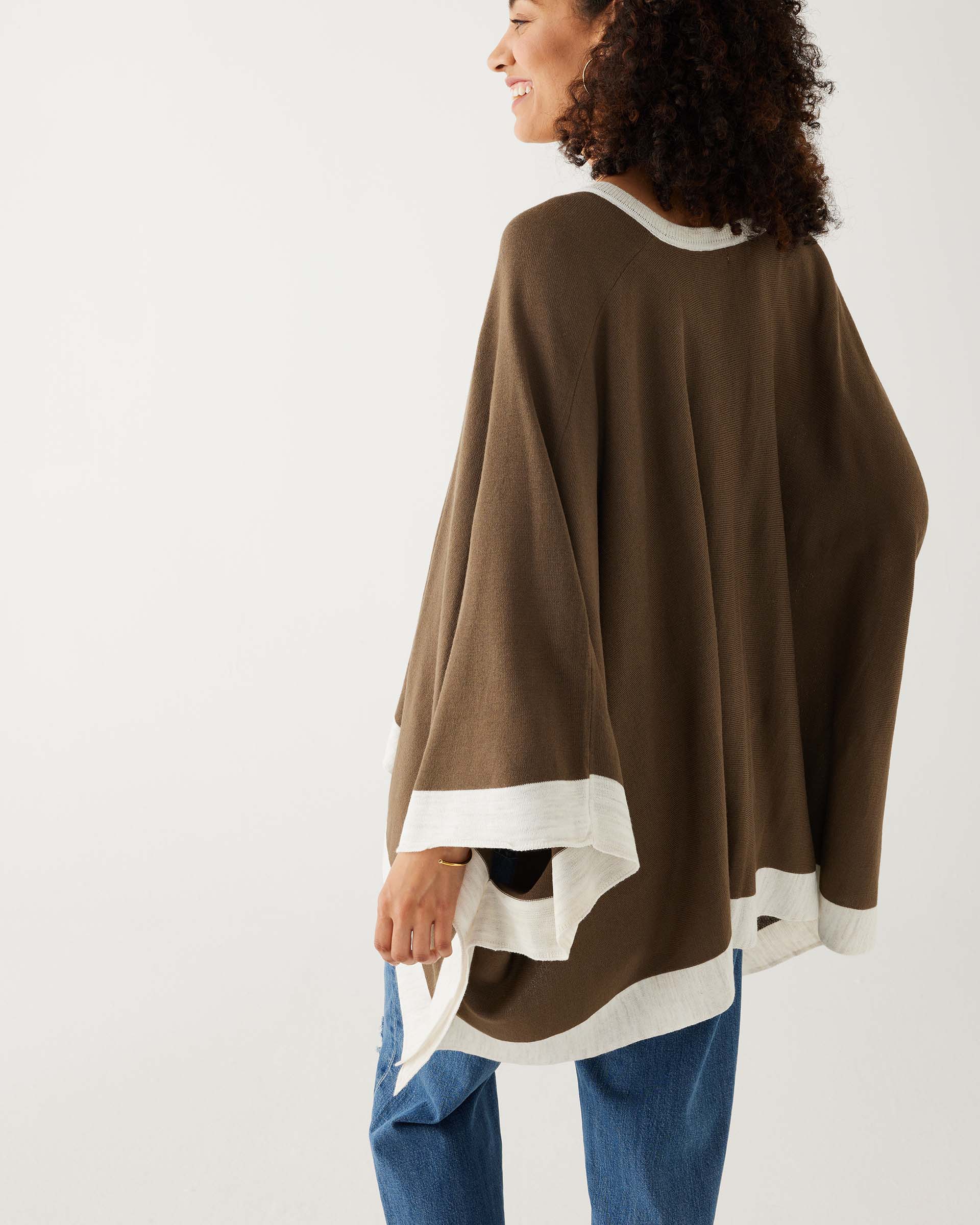 rearview of woman wearing mersea olive and sea salt avalon poncho