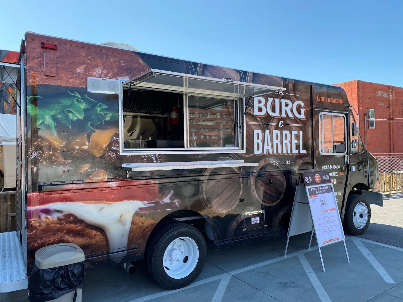 Burg & Barrel food truck with a menu stand in front on a clear day.
