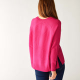 rear view of woman wearing mersea banff cashmere sweater in hot magenta