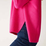 closeup of sweater side split on woman wearing mersea banff cashmere sweater in hot magenta