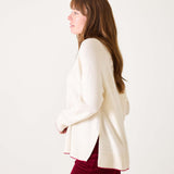 White sweater with red text 'La Rebel' worn by a person on a white background
